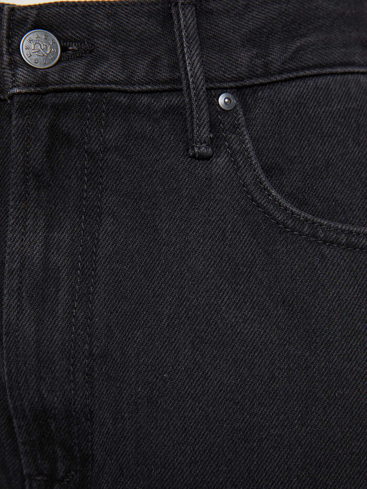 Swatch view of  woman in a black high waisted jean with a wide leg  with a curved outer seam and a long 32 inch inseam with a clean hem.