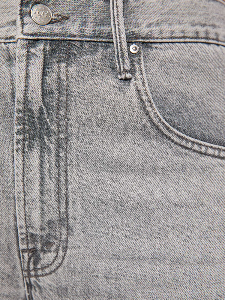 Swatch view of a woman in a washed grey high-rise jeans have a zip fly, a loose wide leg with a curved outer seam and a 32-inch inseam with a clean hem.