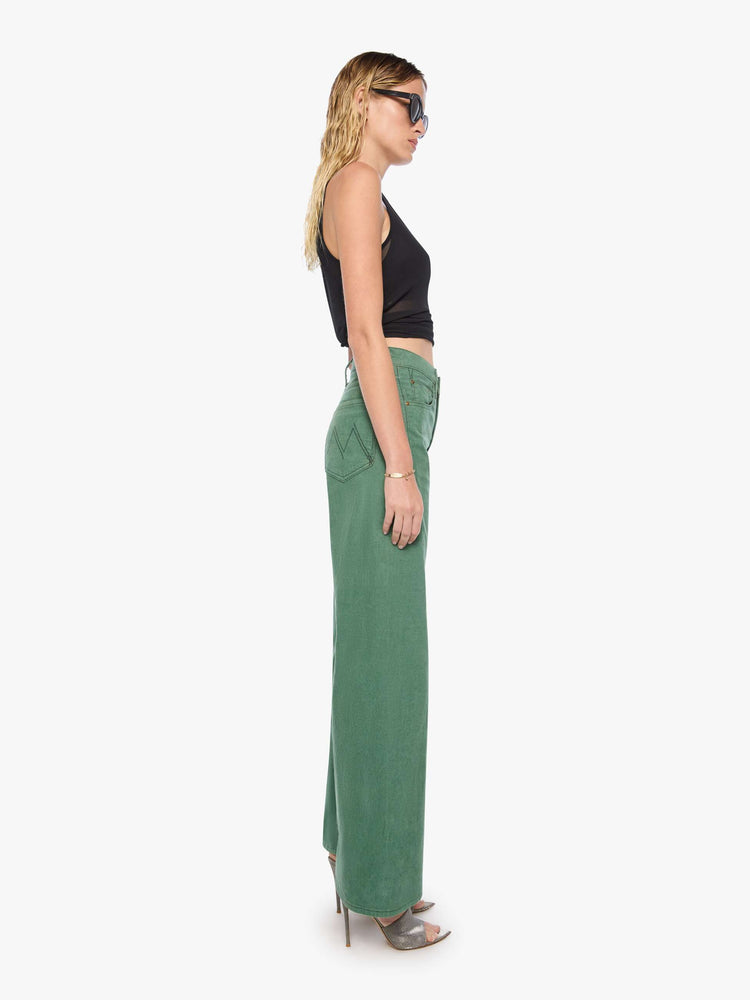 Side view of a woman in wide leg corduroy designed to sit on the hips with a slouchy fit, these high-rise pants have a zip fly, a loose wide leg with a curved outer seam and a 32-inch inseam with a clean hem.