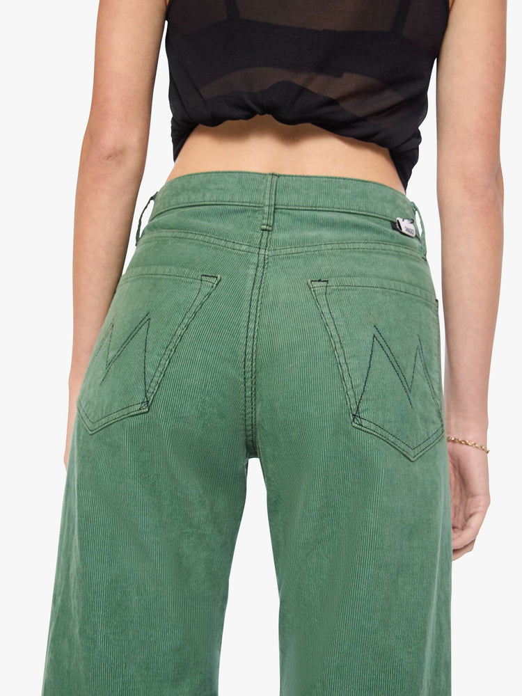 Back close up view of a woman in wide leg corduroy designed to sit on the hips with a slouchy fit, these high-rise pants have a zip fly, a loose wide leg with a curved outer seam and a 32-inch inseam with a clean hem.