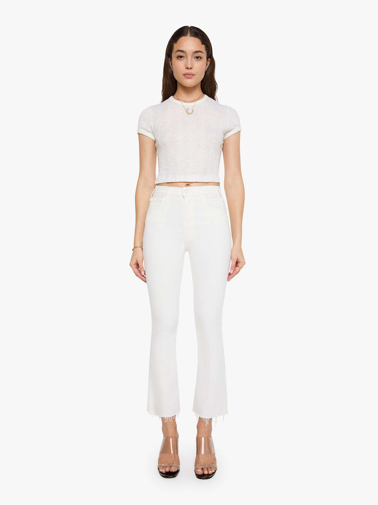 Front view of a womens white wash jean featuring a high rise, flare leg, and a frayed hem.