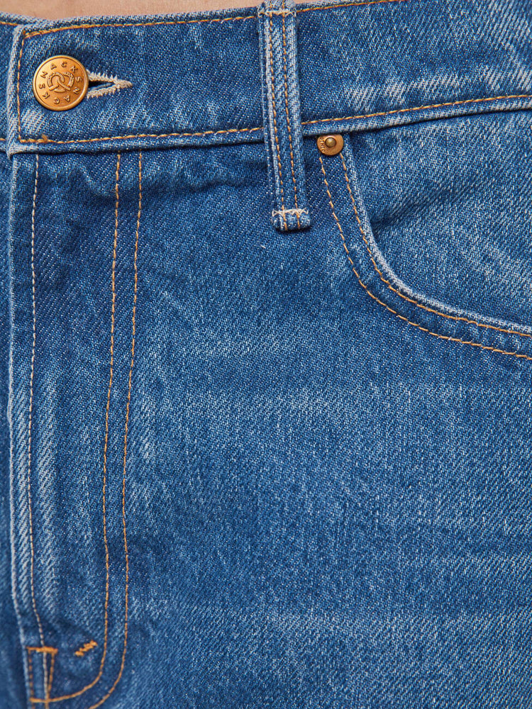 Swatch view of a woman in mid blue  low-slung jeans with a zip fly, long 33-inch inseam with a loose leg and slouchy fit. 