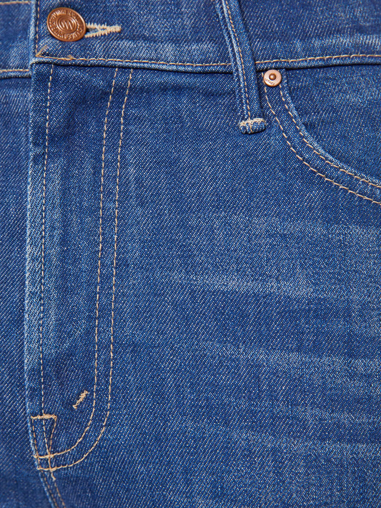 Swatch view of a woman in a mid blue high-rise straight leg jean with a zip fly, 28.25-inch inseam and a clean hem.