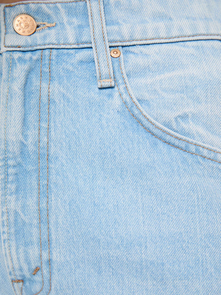 Swatch view of a woman in light blue denim with a straight super high-waisted pants have a zip fly and an ankle-length inseam.