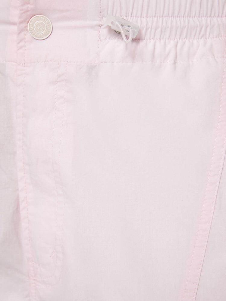 Swatch view of a woman in pink wide-leg pants with an elastic drawstring waist, patch pockets on the thighs, seamed details and a long inseam with adjustable elastic hems.