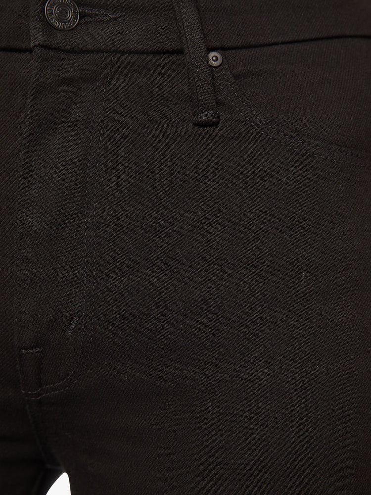 Close up detail view of a black wash denim.