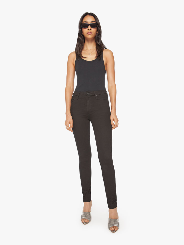 Front view of a womens black skinny jean, featuring a high rise and a clean hem.