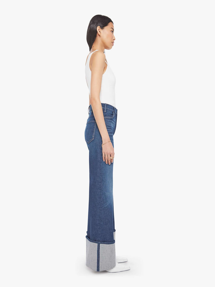 Side view of a woman wide leg jeans with a high rise, zip fly and a long 32-inch inseam with an extra-wide cuffed hem.