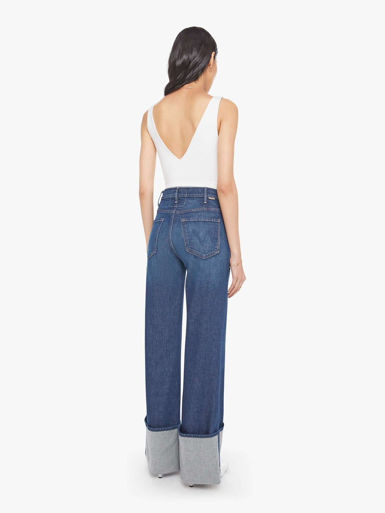 Back view of a woman wide leg jeans with a high rise, zip fly and a long 32-inch inseam with an extra-wide cuffed hem.