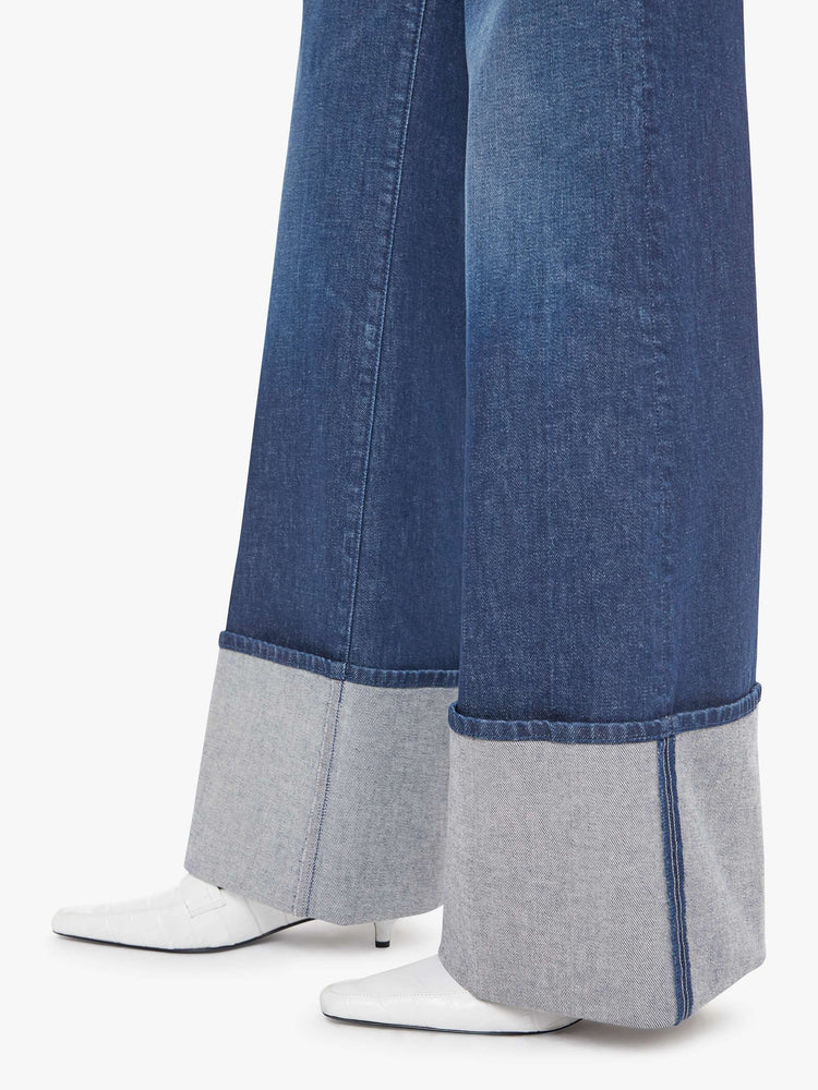 Hem view of a woman wide leg jeans with a high rise, zip fly and a long 32-inch inseam with an extra-wide cuffed hem.