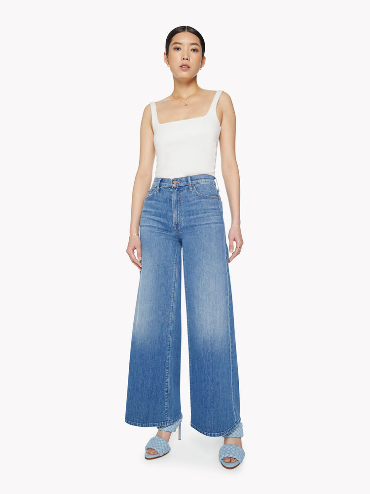 Front view of a woman wide leg pants with a high rise, long 32-inch inseam and a clean hem in a med blue wash. 