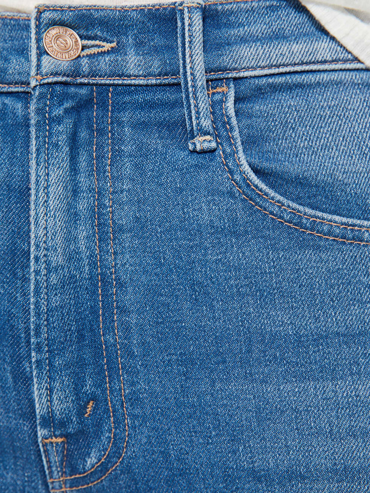 Swatch view of woman in a mid blue high-rise flare has a zip fly, 31-inch inseam and a clean hem.