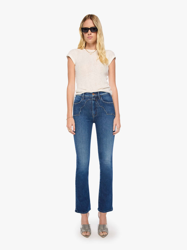 Front view of a woman in high-rise flare with Western-inspired details at the waist, a zip fly, 31-inch inseam and a clean hem.