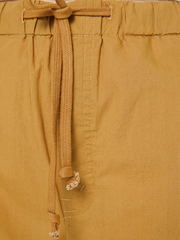 Swatch view of a woman in a super high-waisted pants with a drawstring waistband, wide, curved leg, an ankle-length inseam and a clean hem.