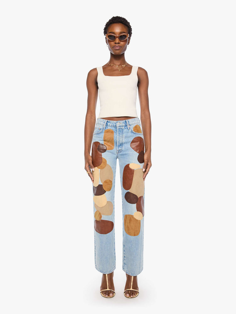 Front view of a woman in a light blue with faux leather and suede patches on the front jean with a high-rise straight-leg with a zip fly, 32-inch inseam and a clean hem