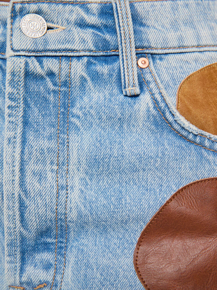 Swatch view of a woman in a light blue with faux leather and suede patches on the front jean with a high-rise straight-leg with a zip fly, 32-inch inseam and a clean hem