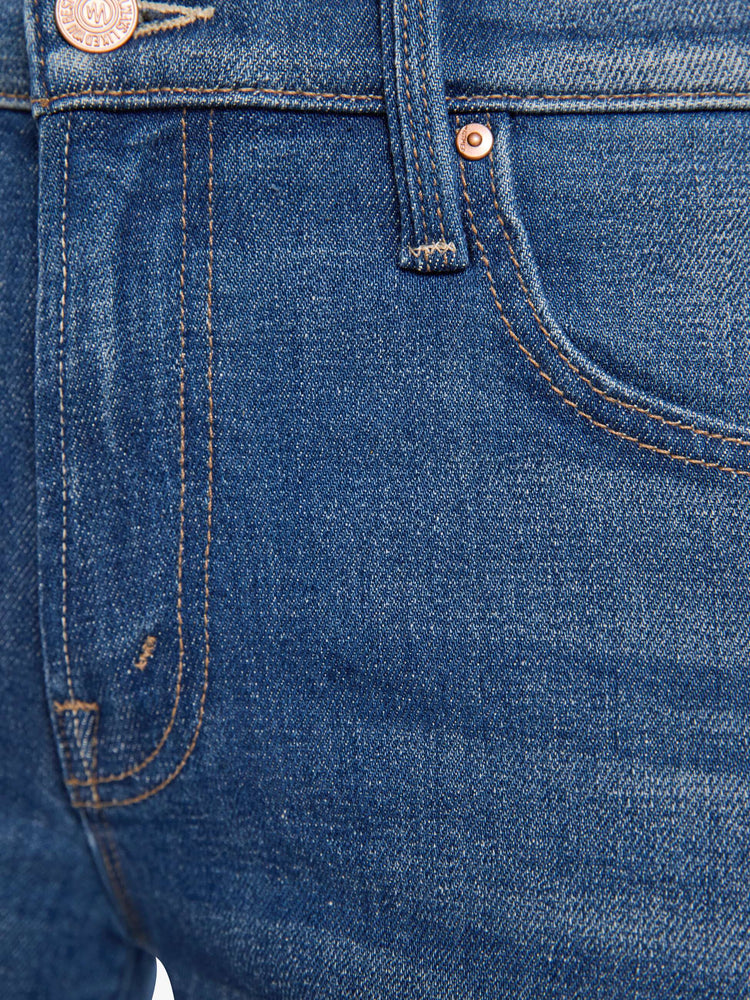 Swatch view of a woman in a mid-rise jeans with a wide straight leg, zip fly and a 28.25-inch inseam with a frayed hem.