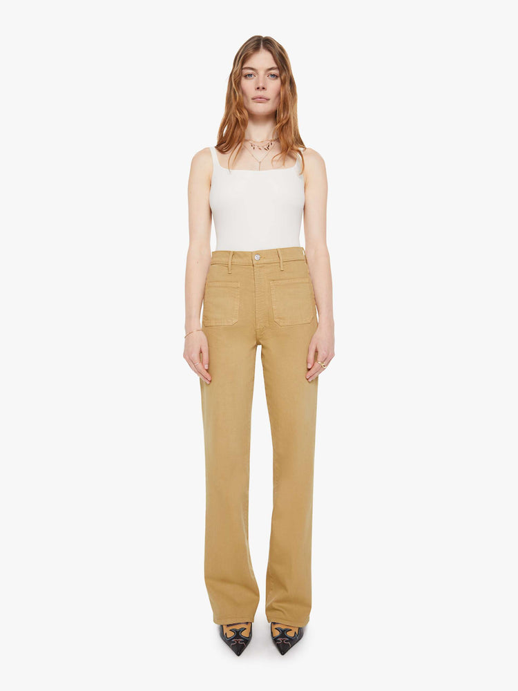 Front view of a woman in a  high-rise bootcut with a zip fly, patch pockets, looser leg and a long 32-inch inseam with a clean hem