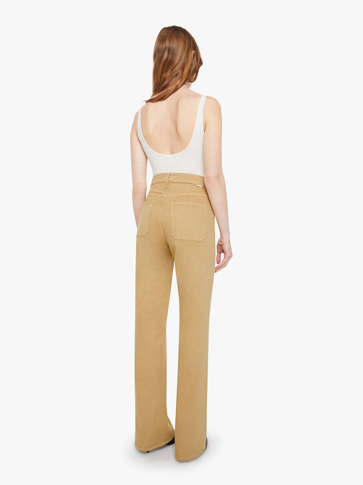 Back view of a woman in a  high-rise bootcut with a zip fly, patch pockets, looser leg and a long 32-inch inseam with a clean hem