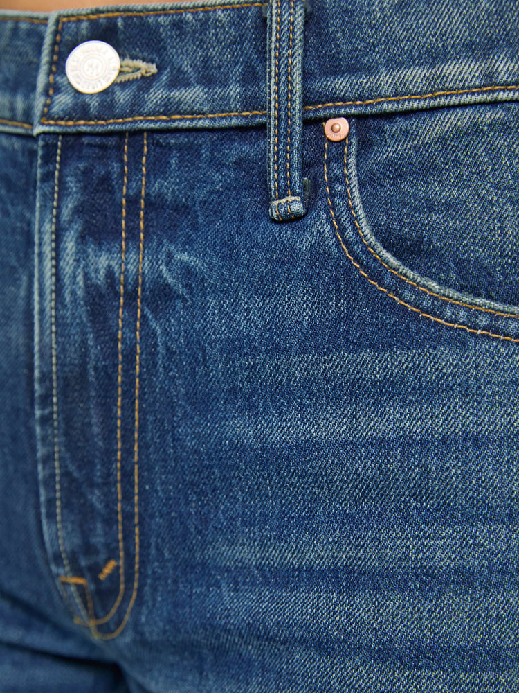 Swatch view of a woman in a  straight leg with a bit of a kick, the jean features a mid rise, full-length inseam and clean hem in a classic blue.