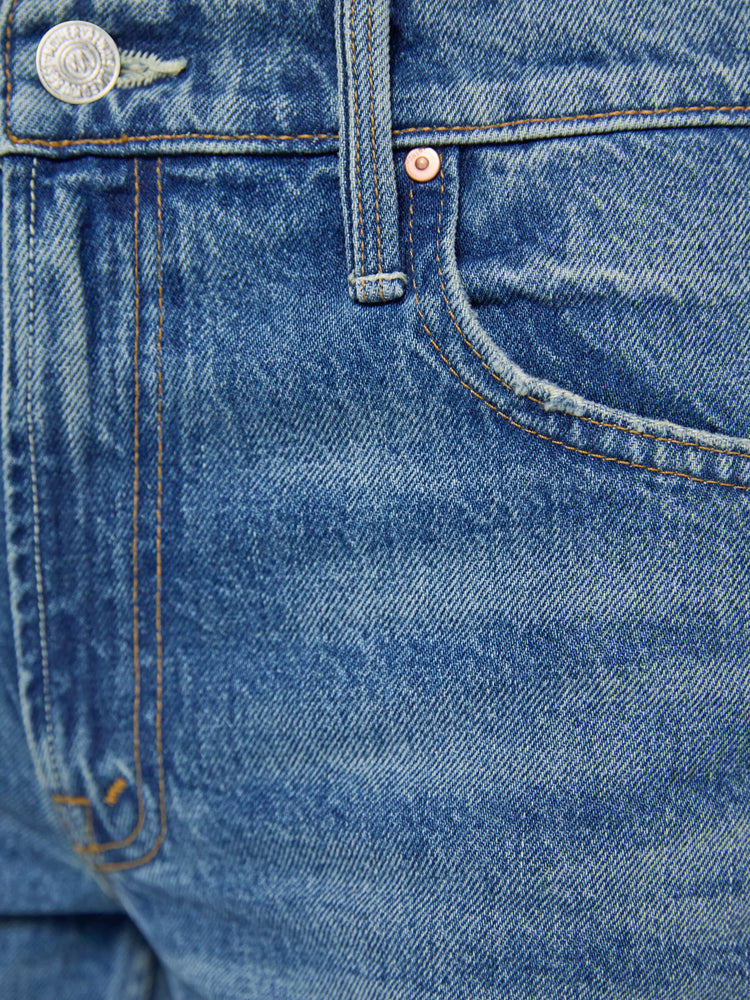 Swatch view of a woman in a  straight leg with a bit of a kick, the jean features a mid rise, full-length inseam and clean hem in med blue wash.
