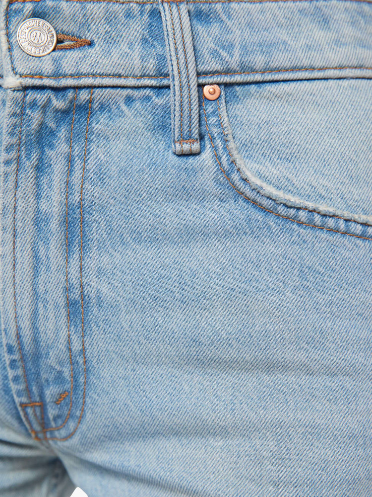 Swatch view of a woman in a light blue straight leg with a bit of a kick, the jean features a mid rise, full-length inseam, distressed hem and relaxed fit.