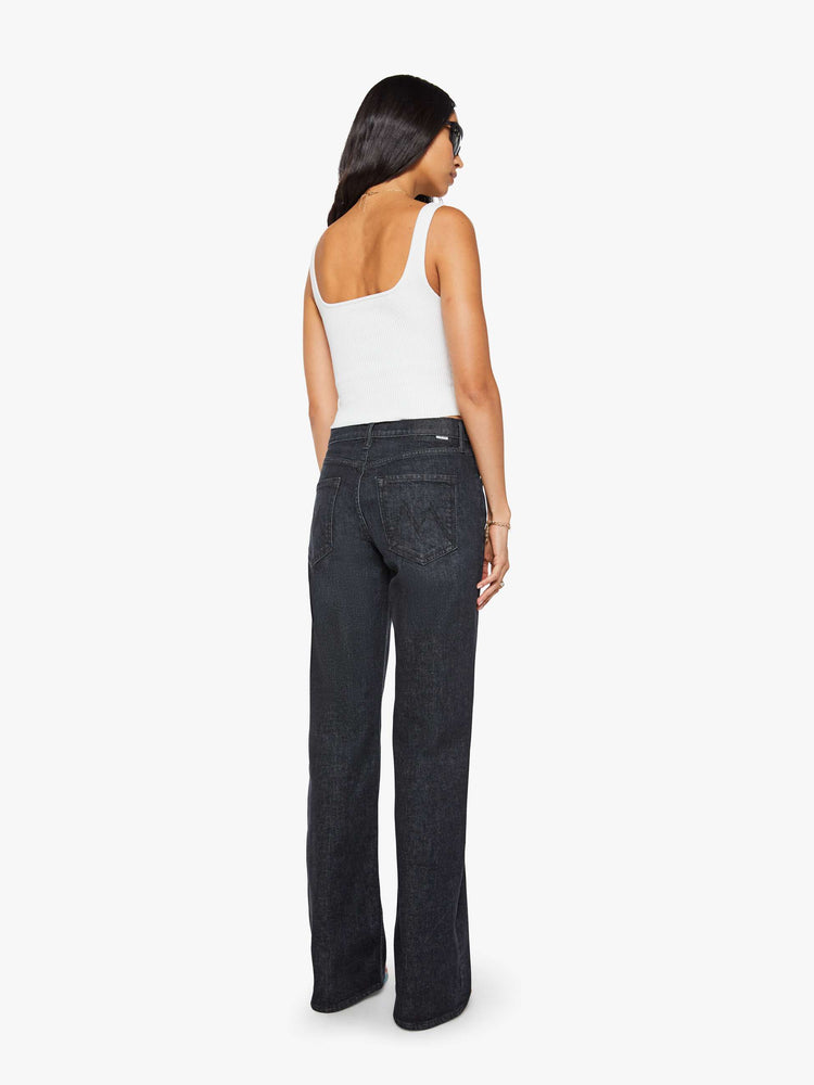 Back view of a woman in black straight leg with a bit of a kick, the jean features a mid rise, full-length inseam, distressed hem and relaxed fit.