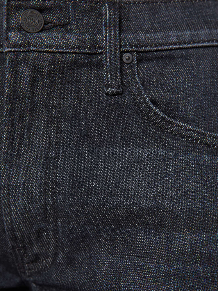 Swatch view of a woman in black straight leg with a bit of a kick, the jean features a mid rise, full-length inseam, distressed hem and relaxed fit.