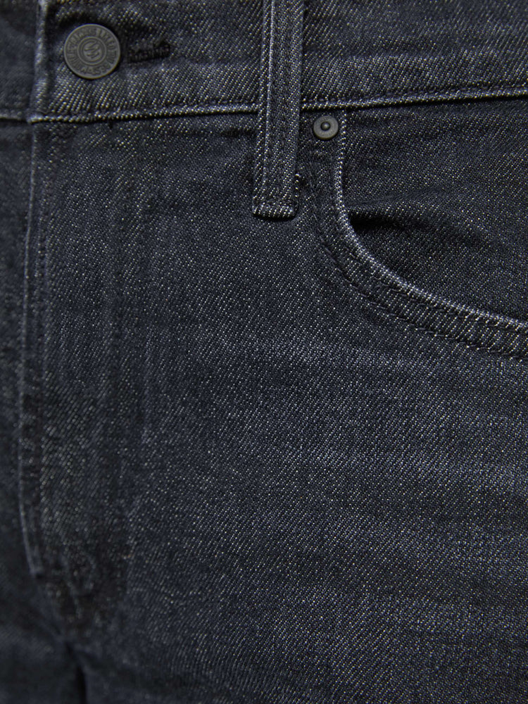 Swatch view of a woman in black straight leg with a bit of a kick, the jean features a mid rise, full-length inseam, distressed hem and relaxed fit.
