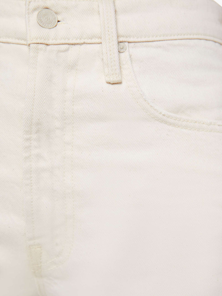 Swatch view of a woman in ivory jean designed to sit on the hips with a slouchy fit with a flared leg, zip fly, a 32.75-inch inseam and a super high rise with a slightly dropped crotch.