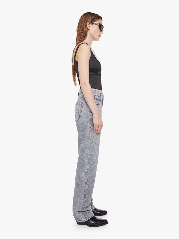 Side view of a woman in a grey  lower-rise jeans have a zip fly, narrow straight-leg and a long 34-inch inseam with a clean hem. 