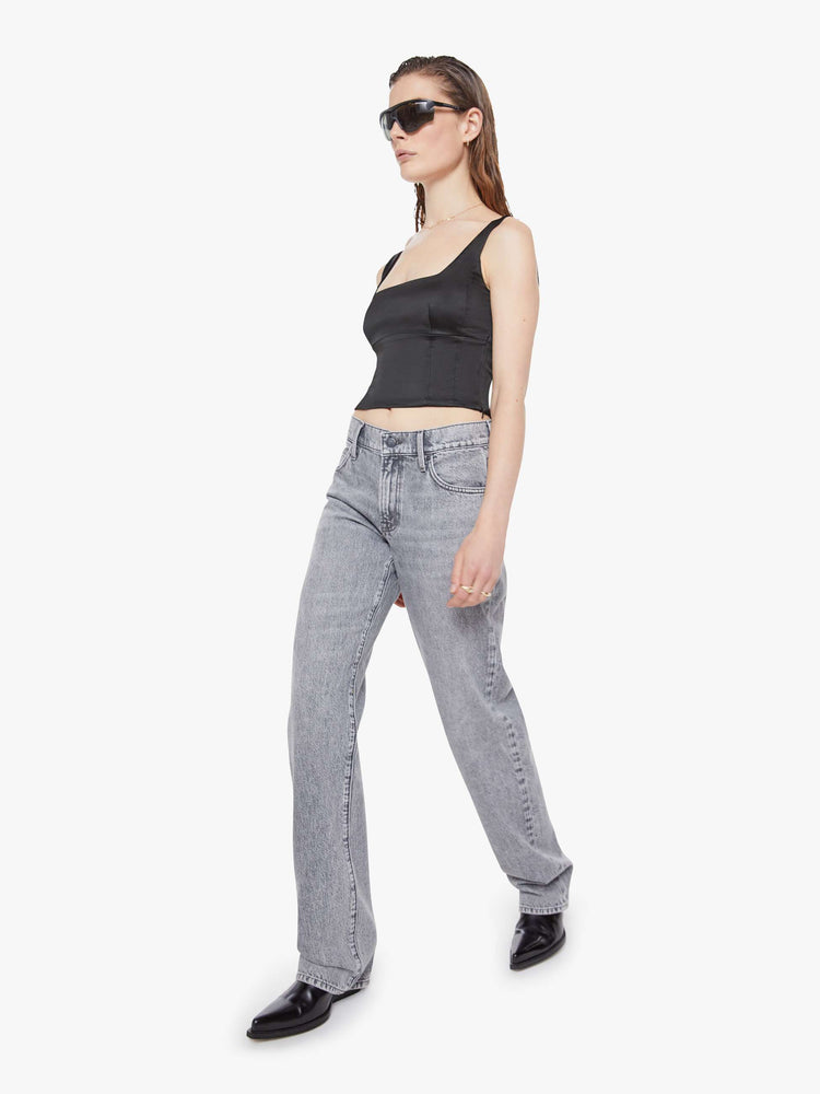 Walking view of a woman in a grey  lower-rise jeans have a zip fly, narrow straight-leg and a long 34-inch inseam with a clean hem. 