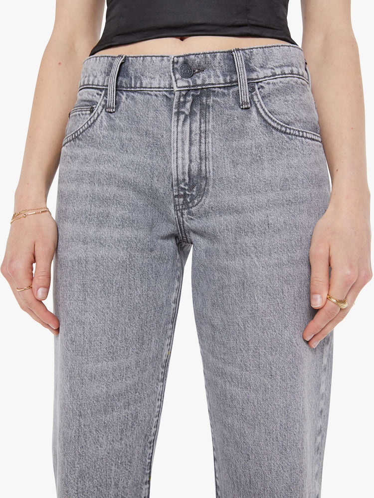 Close up view of a woman in a grey  lower-rise jeans have a zip fly, narrow straight-leg and a long 34-inch inseam with a clean hem. 