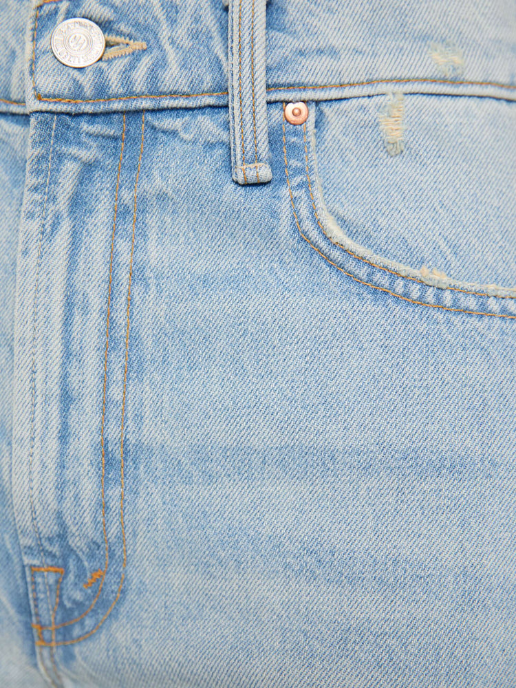 Swatch view of a woman in a light blue high-rise jeans with a wide straight leg, zip fly and long 31-inch inseam with a clean hem. 