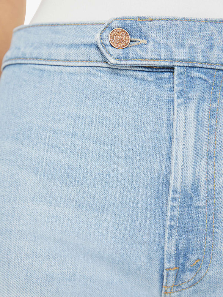 Swatch view of a woman in a light blue high rise wide leg jean, zip fly, tabbed waistband, long 31-inch inseam and a clean hem.
