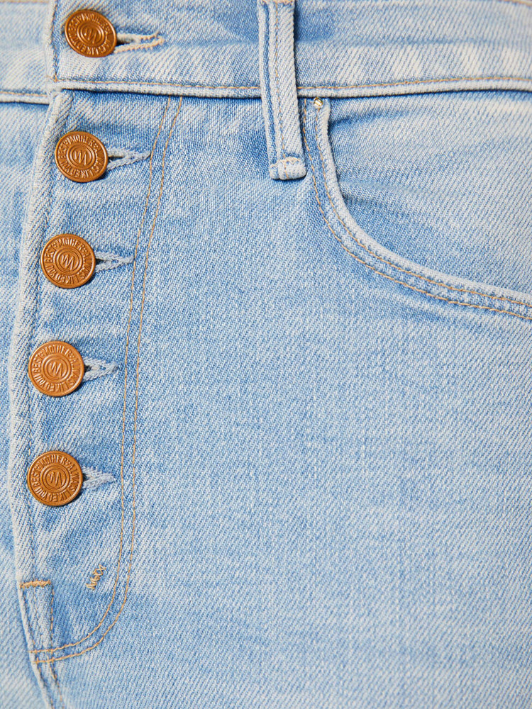 Swatch view of a woman in a light blue  high-rise straight leg has an exposed button fly and a clean ankle-length inseam. 