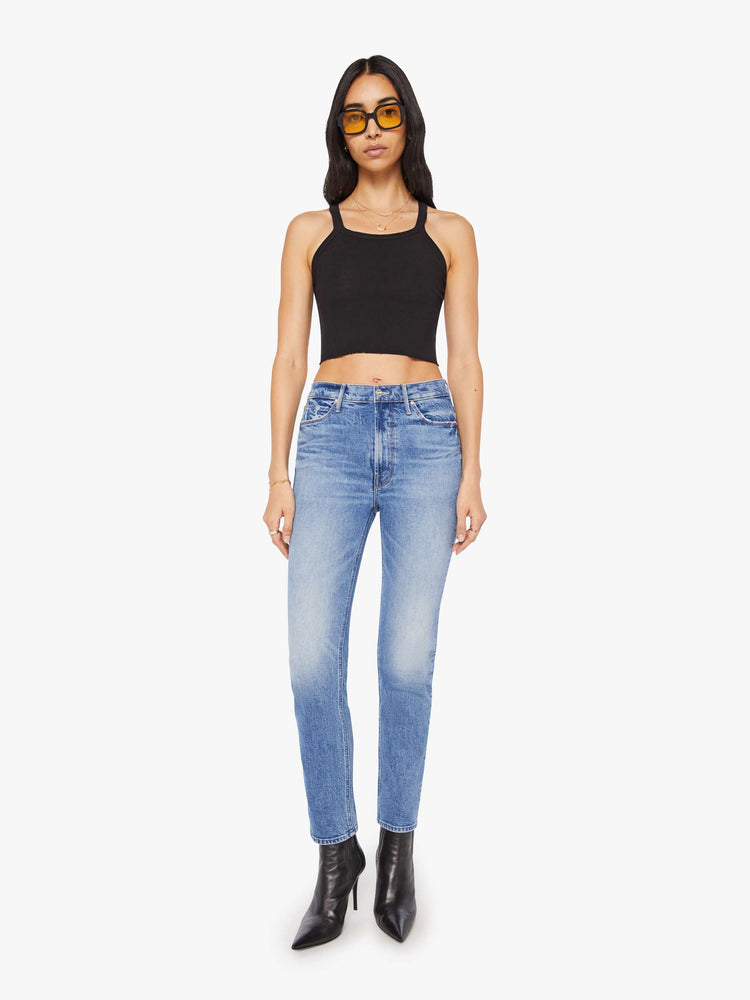 Front view of a woman in a light blue high-rise straight-leg jeans with a 28.25-inch inseam and a clean hem.