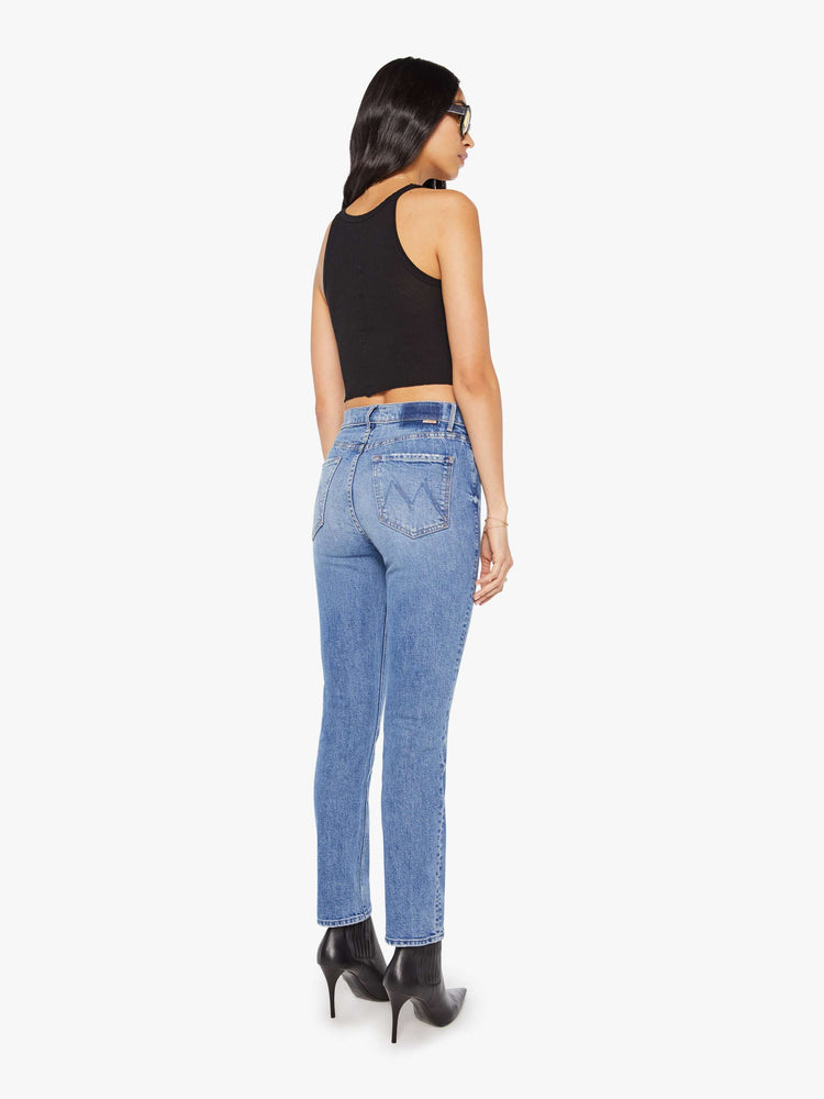 Back view of a woman in a light blue high-rise straight-leg jeans with a 28.25-inch inseam and a clean hem.