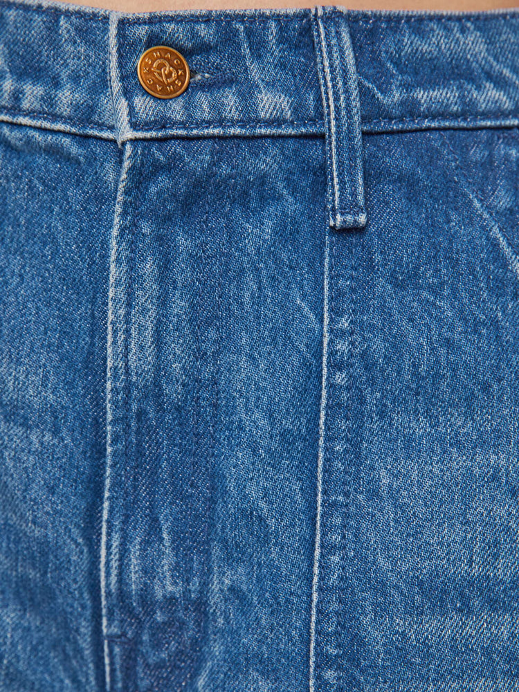 Swatch view of a woman in a mid blue  super high-waisted pants have a zip fly, slouchy fit designed to sit lower on the hips, oversized patch pockets and an ankle-length inseam with soft ribbed hems. 