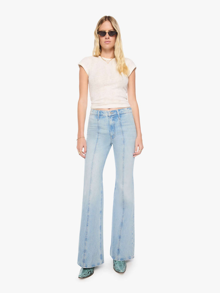 Front view of a woman in a high-rise flare jean with a zip fly, seamed details down the front, a long 34-inch inseam and a clean hem.