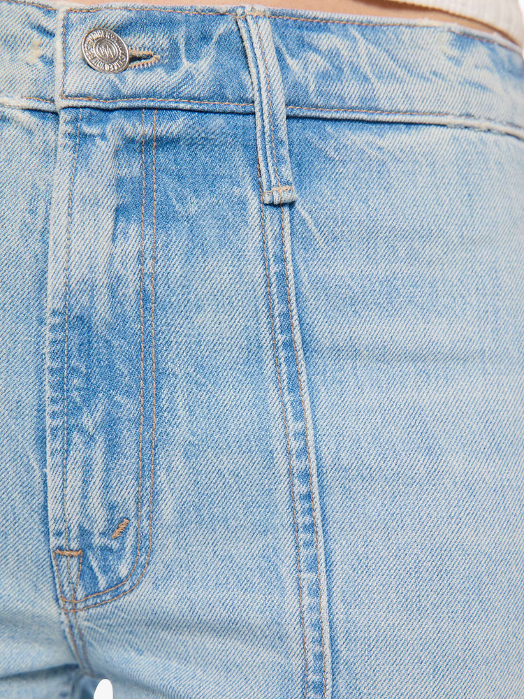 Swatch view of a woman in a high-rise flare jean with a zip fly, seamed details down the front, a long 34-inch inseam and a clean hem.