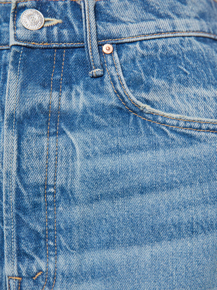 Swatch view of a woman in a med blue super high-waisted barrel-leg jeans with a long 32-inch inseam, a button fly, inset panels on the outer seams, a clean hem and relaxed fit.