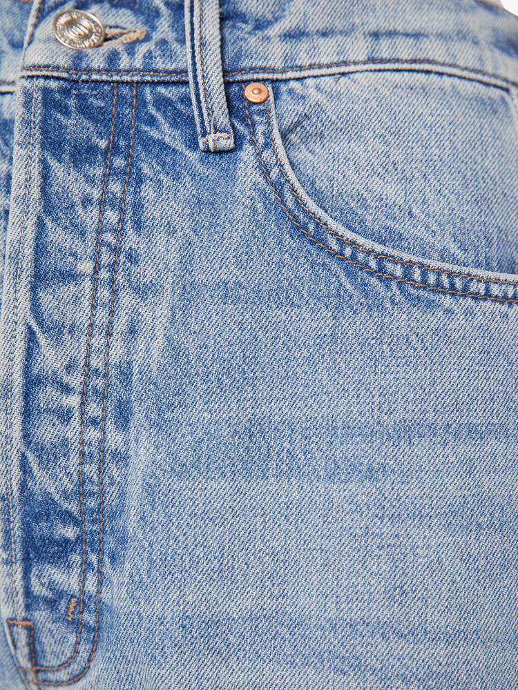 Swatch view of a woman in a light blue super high-waisted barrel-leg jeans with a long 31-inch inseam, button fly, clean hem and relaxed fit.