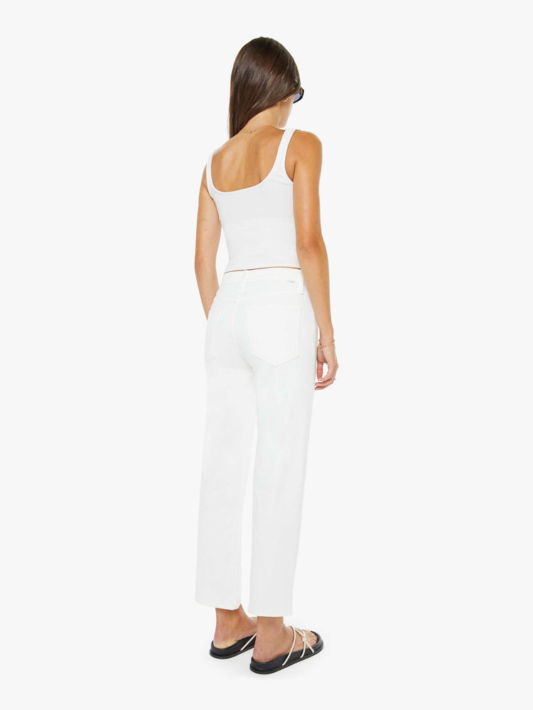 Back view of a woman in a white high-rise jeans with a straight leg, zip fly and an ankle-length inseam with a clean hem. 