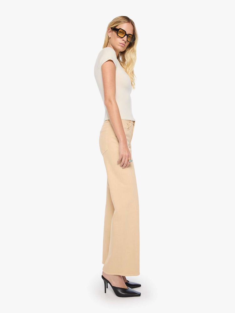 Side view of a woman in a soft khaki mid-rise wide leg with a zip fly, 32-inch inseam and a clean hem.