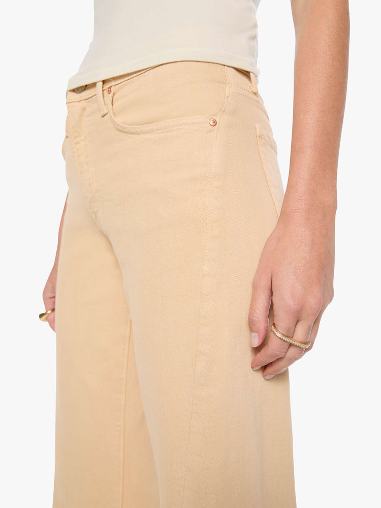 Close up view of a woman in a soft khaki mid-rise wide leg with a zip fly, 32-inch inseam and a clean hem.