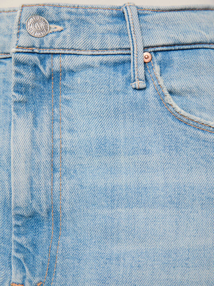 Swatch view of a woman n a light blue denim with flame on the side bootcut jeans with a high rise, zip fly and seamless finish on the outer leg.