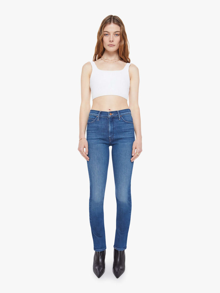 Front view of woman in a mid blue mid-rise jean has a straight leg, zip fly, 29-inch inseam and a clean hem.