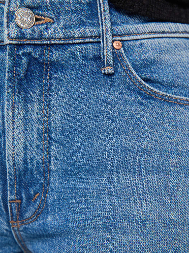 Swatch view of a woman in mid blue mid-rise jean has a straight leg, zip fly, 29-inch inseam and a clean hem. 
