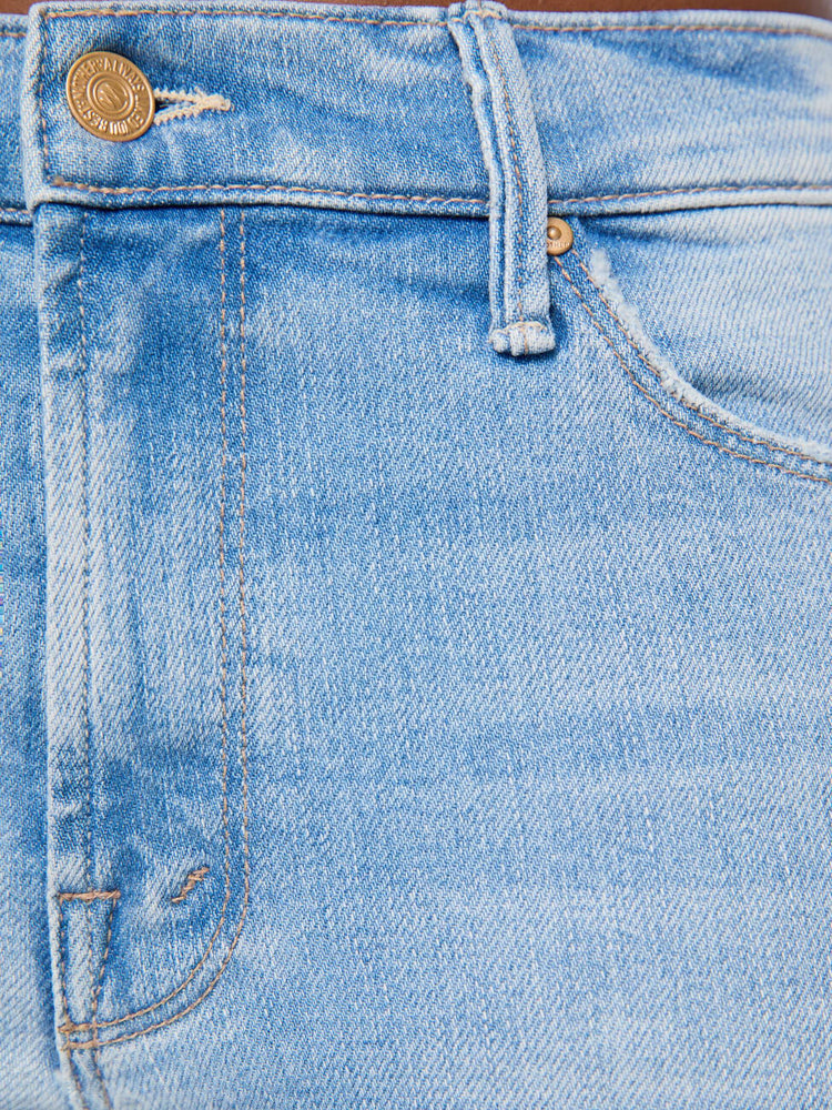 Swatch view of a woman in light blue mid-rise jean has a straight leg, zip fly, 29-inch inseam and a clean hem.